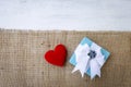 Blue gift box with red heart on hessian fabric Royalty Free Stock Photo