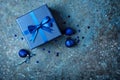 Blue gift box with shiny satin bow and christmas decorations Royalty Free Stock Photo