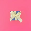 Blue gift box on cherry pink background. square . Royalty Free Stock Photo