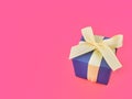 Blue gift box on cherry pink background, copy space. Royalty Free Stock Photo