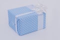 Blue gift box with white satin ribbon. Royalty Free Stock Photo