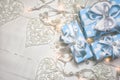 Blue gift boxes and lights with pearls on white wooden background Royalty Free Stock Photo