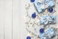 Blue gift boxes and ornaments on white wooden background Royalty Free Stock Photo