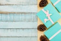 Blue gift boxes with pink ribbons and fircones on wood Royalty Free Stock Photo