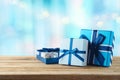 Blue gift boxes on wooden table. Christmas or Hanukkah celebration concept