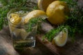 Blue gin , tonic and lemon slices on a old wooden table. Royalty Free Stock Photo