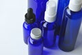 Blue glass bottles for cosmetic lotions, serums, oils Royalty Free Stock Photo