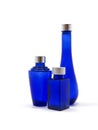 Blue glass bottles. Empty, decorative, on white background. Royalty Free Stock Photo