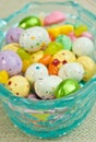 A blue, glass easter basket, filled with candy easter eggs Royalty Free Stock Photo