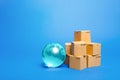 Blue glass globe and cardboard boxes. International world trade distribution. Delivery of goods, shipping. Global economy, import