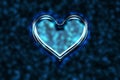 Blue glass heart. Valentine`s day. Glossy heart shape on a shiny background.