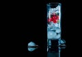 Blue Glass of ice with berry gooseberries red black currants and water. Refreshing cocktail. Summer drink. Royalty Free Stock Photo