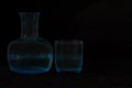 Blue glass jug b glass on black background Royalty Free Stock Photo