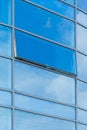 Blue glass reflects cloudy sky modern building facade exterior office texture background abstract Royalty Free Stock Photo