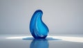 a blue glass sculpture sitting on a table