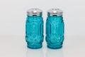 Blue glass and silver topped salt and pepper shakers Royalty Free Stock Photo