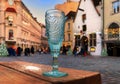 Blue glass of wine ,white cup of coffee and sunglasses on red table top in street cafe ,blue sky,sunny day in the medieval city ,