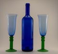 Blue glasses with green stands and bottle