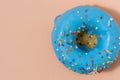 Blue glazed donut with sprinkles on pink background. Royalty Free Stock Photo