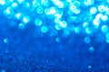 Blue glitter foil Christmas background. Shiny metal blue foil texture abstract defocused background. Sparkle glitter texture with Royalty Free Stock Photo