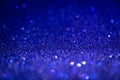 Blue glitter lights. Shiny sparkles, bokeh effects, glowing surface. Selective focus, christmas abstract background Royalty Free Stock Photo