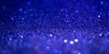 Blue glitter lights. Shiny sparkles, bokeh effects, glowing surface. Selective focus, christmas abstract banner Royalty Free Stock Photo