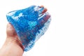 Blue glitter slime on hand