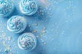 Blue glittering background with cupcakes and copy space. Its a boy backdrop with empty space for text. Baby shower Royalty Free Stock Photo