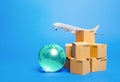 Blue globe, cardboard boxes and freight airplane. International world trade. Deliver goods, shipping. Import export freight