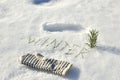 White glove with text `Winter` of spruce needles on a background of white snow