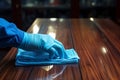 Blue gloved hand caresses the table, ensuring pristine cleanliness