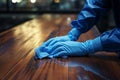 Blue gloved hand caresses the table, ensuring pristine cleanliness