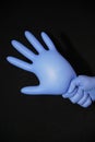 Blue gloved hand, holding a filled syringe, squirting down Royalty Free Stock Photo