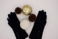 Blue gloves, white and golden Christmas balls and two pine cones on a white background. New YearÃ¢â¬â¢s and Christmas Concept Royalty Free Stock Photo