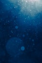 Blue light background with snowflakes particles Royalty Free Stock Photo