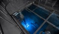 Blue glow water of nuclear reactor core powered, caused by Cherenkov radiation, fuel plates industrial uran