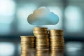 Blue glowing cloud computing icon on a pile of gold coins against blue blurred background. Royalty Free Stock Photo