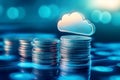 Blue glowing cloud computing icon on a pile of gold coins against blue blurred background. Royalty Free Stock Photo