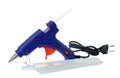 Blue glue gun and sticks on white background