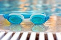 Blue goggles by the pool Royalty Free Stock Photo