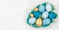 Blue and gold Easter eggs in ceramic bowl with copy space on white background Royalty Free Stock Photo
