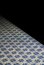 Blue and gold traditional Thai tablecloth over black background Royalty Free Stock Photo