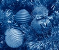 blue and golden christmas balls on a golden tinsel Royalty Free Stock Photo