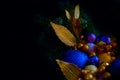 Blue and golden Christmas balls on a christmas tree closeup view in a low key with a copy space Royalty Free Stock Photo