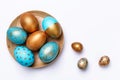 Blue and golden modern easter eggs on a wooden plate. Royalty Free Stock Photo