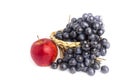 Blue grapes in basket and red apple isolated on white background Royalty Free Stock Photo