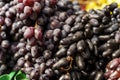 Blue grapes lie on a farmer's market counter. Royalty Free Stock Photo