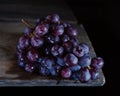 Bunch of grapes lies on a wooden table