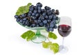 Blue grapes on vintage fruit vase, vine twig, red wine Royalty Free Stock Photo