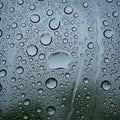 Blue-gray background. The droplets vary in size, some forming elong Royalty Free Stock Photo